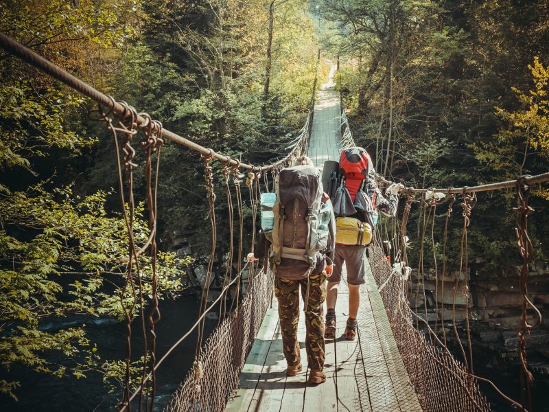 Travelers crossing through hanging bridge